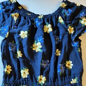 Blue romper with yellow and blue flowers.